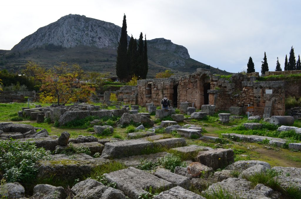 A stone church with a mountain in the background

Description automatically generated