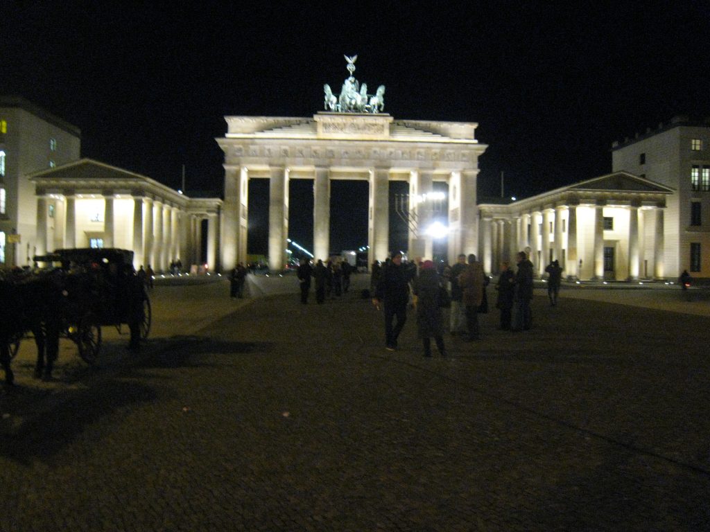 A group of people standing in front of a building

Description automatically generated