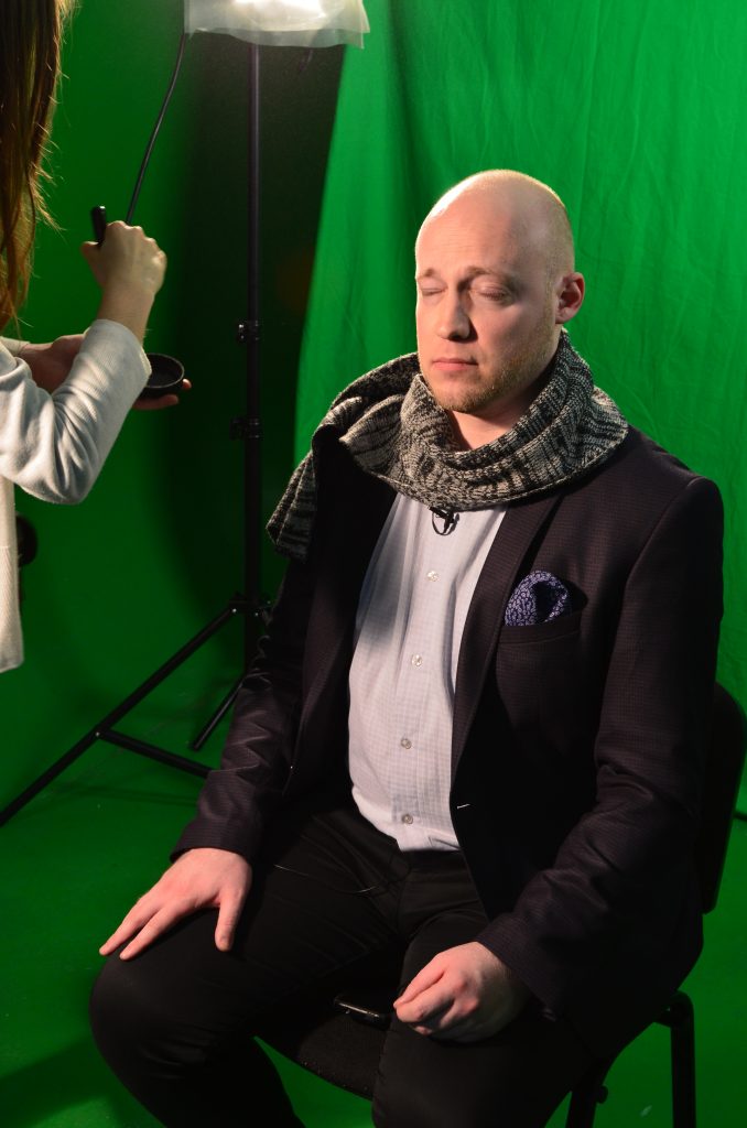 Text Box: Green screening with Pastor Derek who is being given make-up